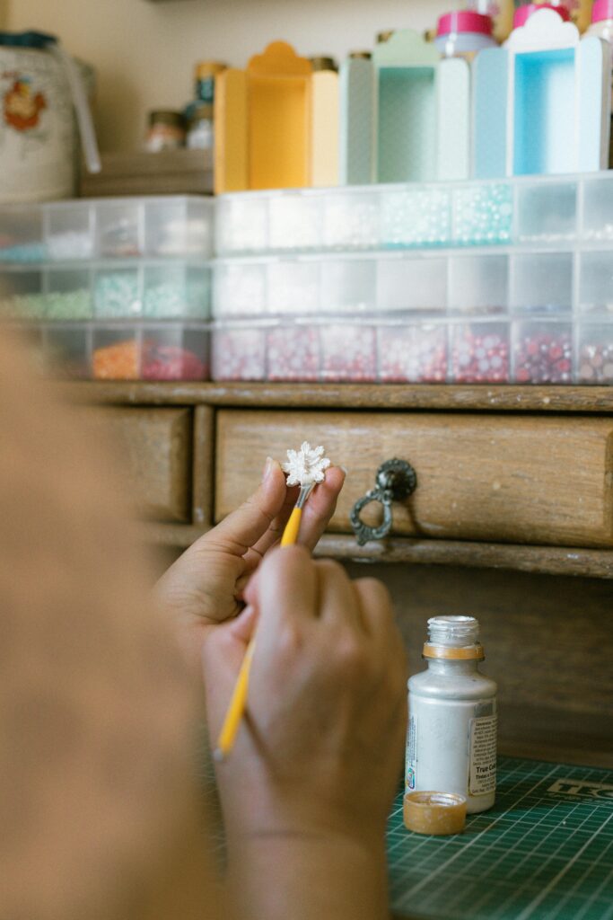 A girl's hand making a piece of jewelry